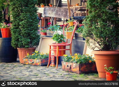 Street cafe terrace with tables and flowers in European city