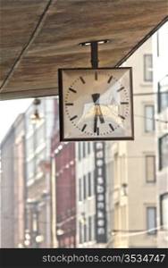 Street clock. Hanging clock on city walk.