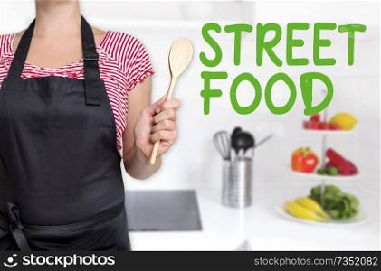street food cook holding wooden spoon background concept.. street food cook holding wooden spoon background concept
