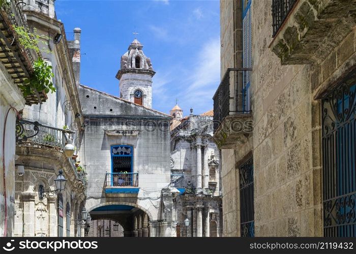 Street in the historical center of the old havana near the Church of St. Christopher, background church and bell tower of cathedral,Havana, Cuba.