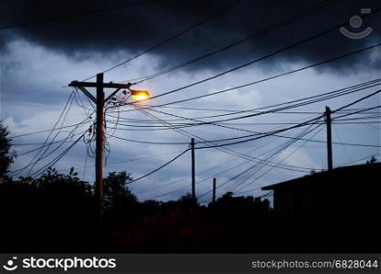 Street light at night with a stormy sky background. Dark mystery scene. Street light at night with a stormy sky background