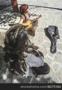 Street musicians playing guitar and drum