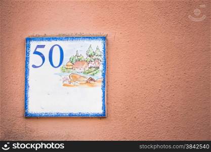 Street number 50. Particular of artistic street number