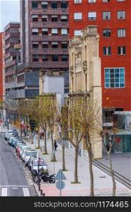 Street of Bilbao, Spain with old ruin and modern buildings