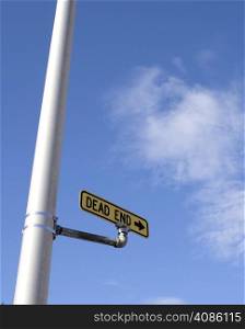 Street Sign indicating Dead End with blue sky and cloud background