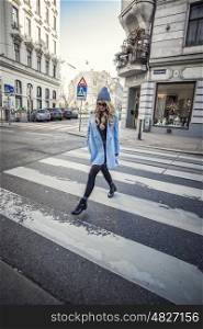 Street Style photo shoot of beautiful fashion blonde woman crossing the street