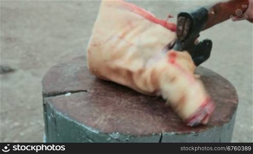 Street vendor cutting fresh pork meat, close-up