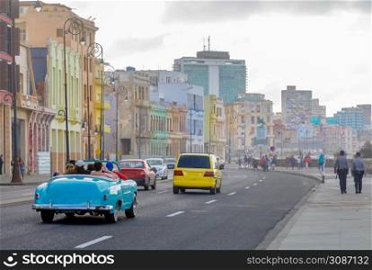 Street with cars and old spanish colonial buildings along the road, in the center of Havana, Cuba