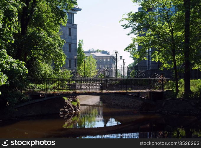 Street with houses over water canal and old bridge