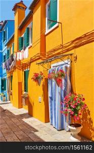 Street with old houses of vivid colors in Burano island in Venice, Italy. Italian cityscape