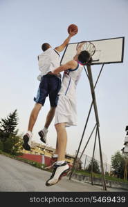 streetball basketball game with two young player at early morning on city court