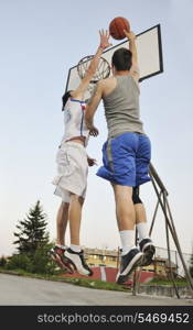 streetball basketball game with two young player at early morning on city court