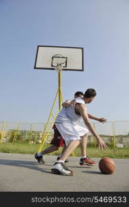 streetball basketball game with two young player at early morning on city court