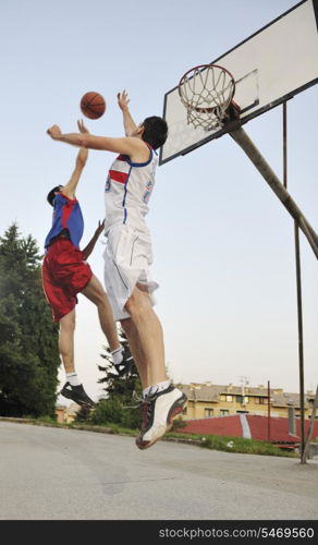 streetball basketball game with two young player at early morning on city court