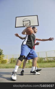 streetball basketball game with two young player at early morning on city court