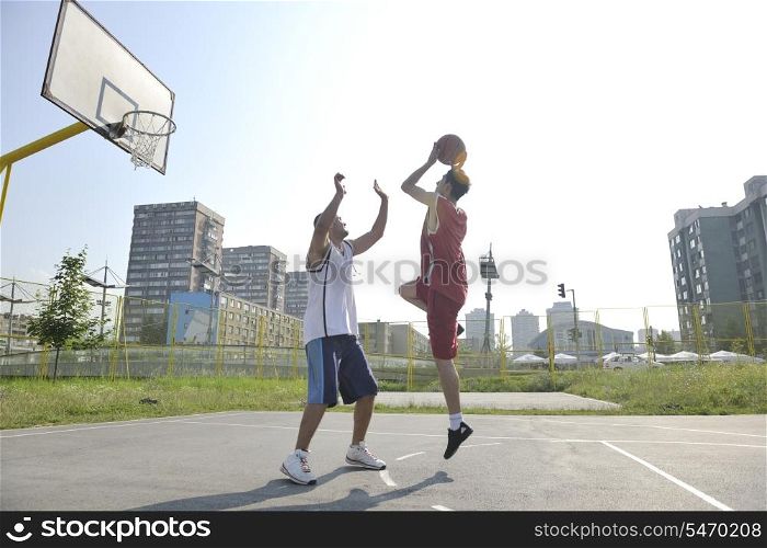 streetball basketball game with two young player at early morning on city court