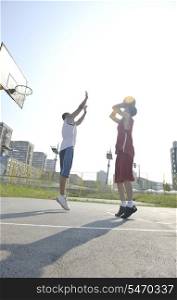 streetball basketball game with two young player at early morning on city court