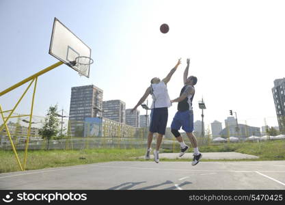 streetball basketball game with two young player at early morning on city court