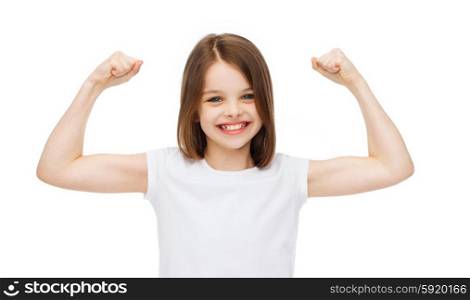strength, health, sport, fitness concept - smiling teenage girl in blank white t-shirt showing muscles