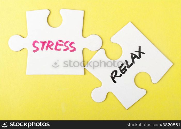 Stress and relax words written on two pieces of jigsaw puzzle