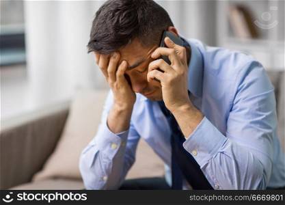 stress, crisis and people concept - unhappy man calling on smartphone. unhappy man calling on smartphone. unhappy man calling on smartphone