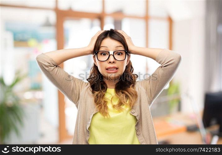 stress, education and school concept - asian woman or student in glasses fixed by tape holding to her head over office background. asian woman in glasses holding to head at office