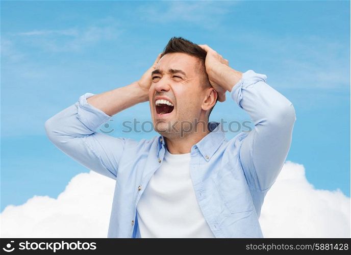 stress, headache, health care and people concept - unhappy man with closed eyes touching his forehead over blue sky and cloud background