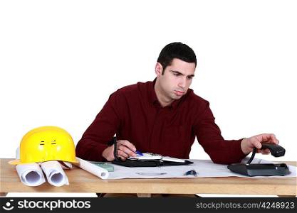 Stressed architect sat at desk