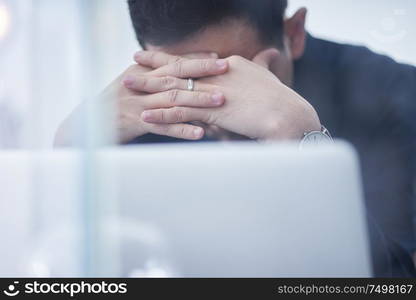 Stressed asian man or businessman at office, failure and headache concept