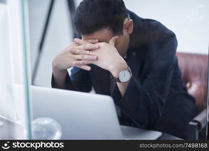 Stressed asian man or businessman at office, failure and headache concept