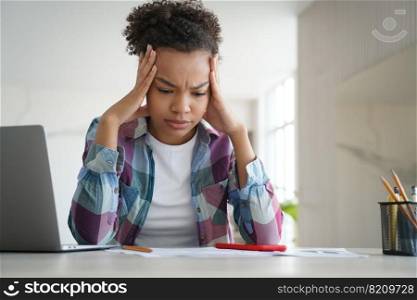 Stressed biracial teen girl student doing homework at laptop. Exhausted teenager schoolgirl worried about educational trouble or bullying at school. Difficult elearning, stress, teenage problems.. Stressed biracial teen girl school student doing homework at laptop. Difficult elearning, stress