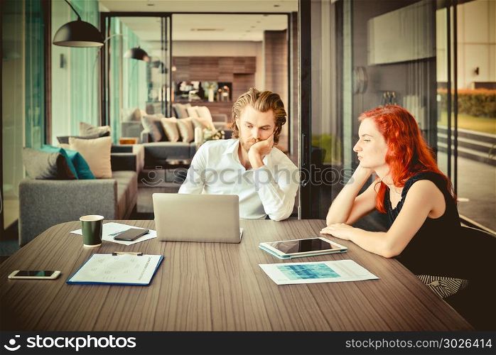 Stressed business people meeting in a meeting room, western busi. Stressed business people meeting in a meeting room, western business team. Stressed business people meeting in a meeting room, western business team