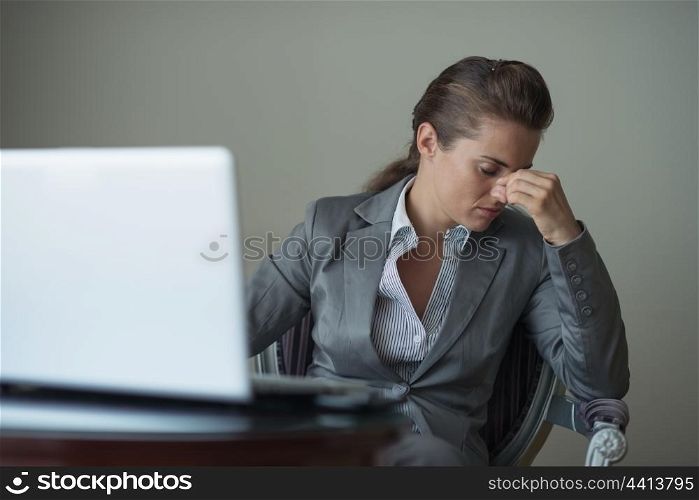 Stressed business woman sitting in hotel room