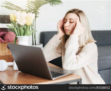Stressed business woman working from home on laptop looking worried and tired 