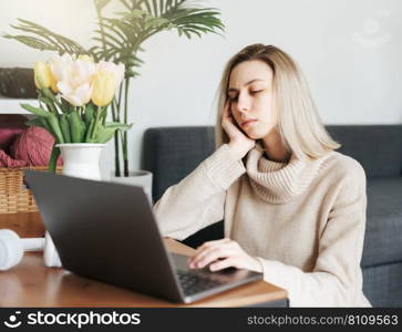 Stressed business woman working from home on laptop looking worried and tired 