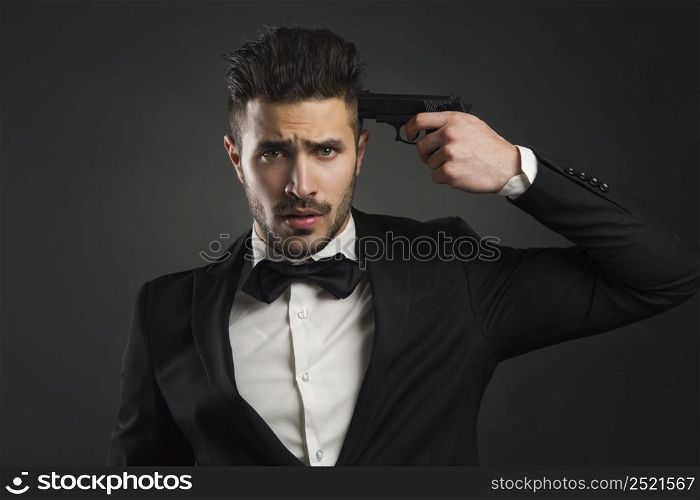 Stressed businessman giving a gunshot on his own head