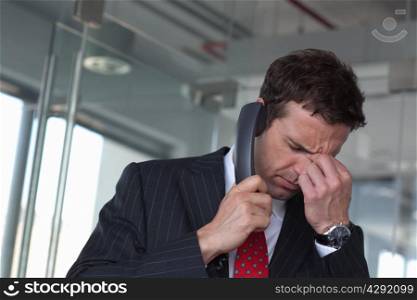 Stressed businessman on phone