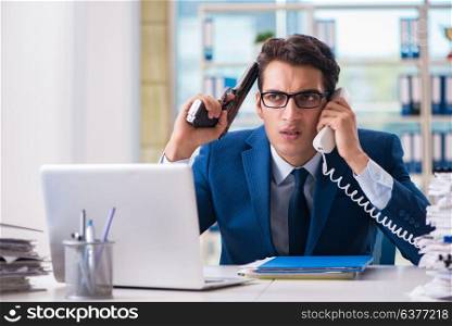 Stressed businessman thinking of suicide due to excessive workload. Stressed businessman thinking of suicide due to excessive worklo