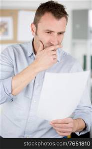 stressed businessman with and documents at office