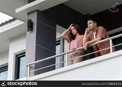 stressed couple quarantine in balcony of the home, coronavirus pandemic concept