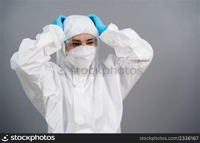 stressed doctor in protective PPE suit during coronavirus covid-19  pandemic