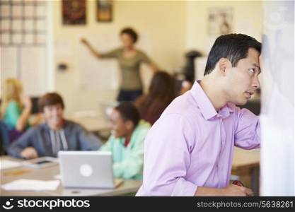 Stressed High School Teacher Trying To Control Class