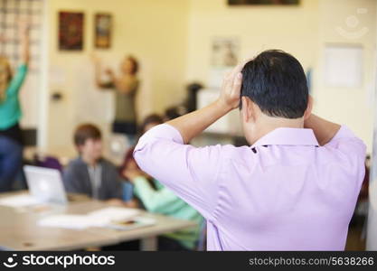 Stressed High School Teacher Trying To Control Class