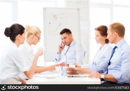 stressed male boss on business meeting with team in office