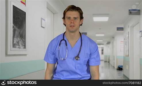 Stressed man in medical clothing at work