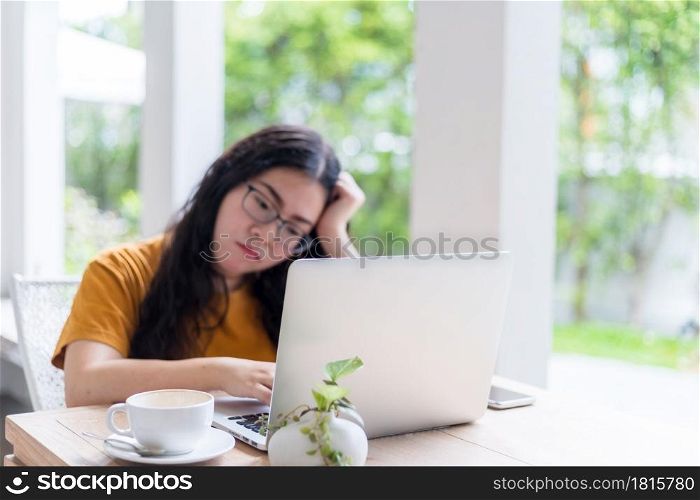 Stressed of freelance people business female wearing protective mask casual having a headache after business losses working with laptop in coffee shop background,working from home,Concept of COVID-19