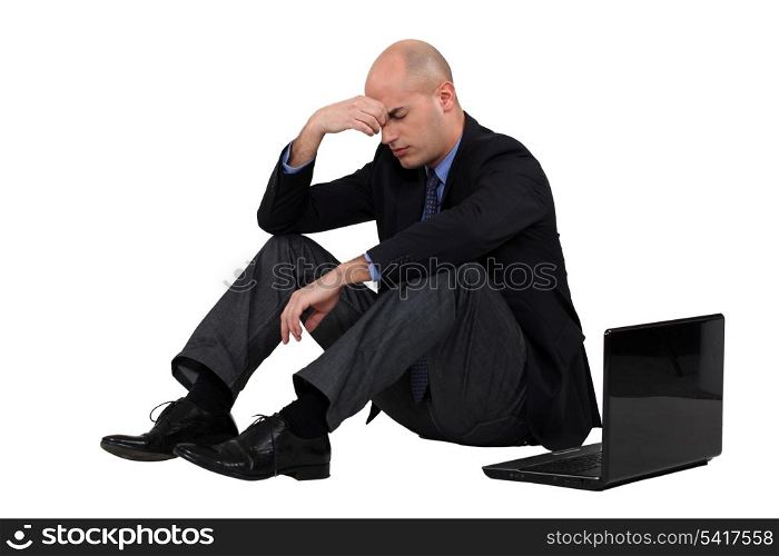 Stressed out businessman with his laptop