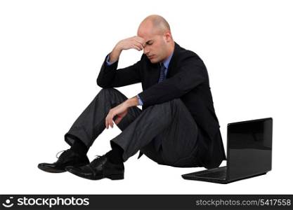 Stressed out businessman with his laptop