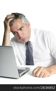 stressed senior businessman gesture working laptop computer white desk