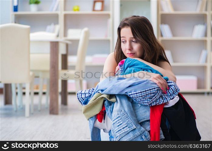Stressed woman doing laundry at home